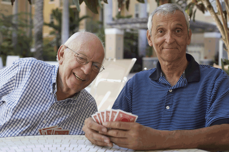 Two senior men playing a card game.